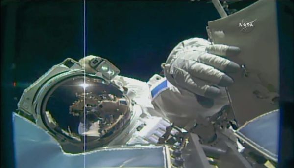 SPACEWALKING ASTRONAUTS PREP SPACE STATION TO DOCK WITH COMMERCIAL SPACESHIPS
