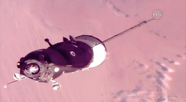SOYUZ WITH THREE-MAN CREW DOCKS WITH SPACE STATION