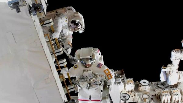 ASTRONAUTS INSTALL NEW BATTERIES OUTSIDE THE INTERNATIONAL SPACE STATION