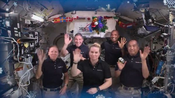 ASTRONAUTS ON THE INTERNATIONAL SPACE STATION BEAM CHRISTMAS CHEER TO EARTH
