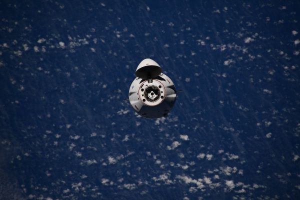 DRAGON SUPPLY FREIGHTER DOCKS AT SPACE STATION WITH 2.4 TONS OF CARGO