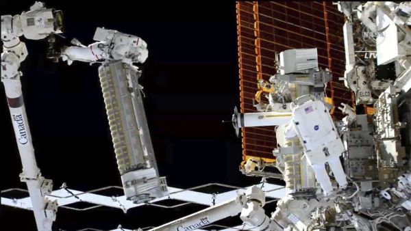 Astronauts install new solar array outside International Space Station